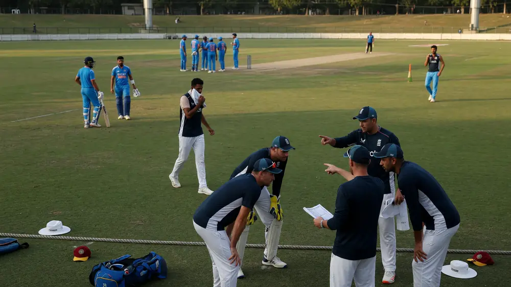 Fielders in position on a green outfield during a tactical T20 phase with the pitch and ring field visible